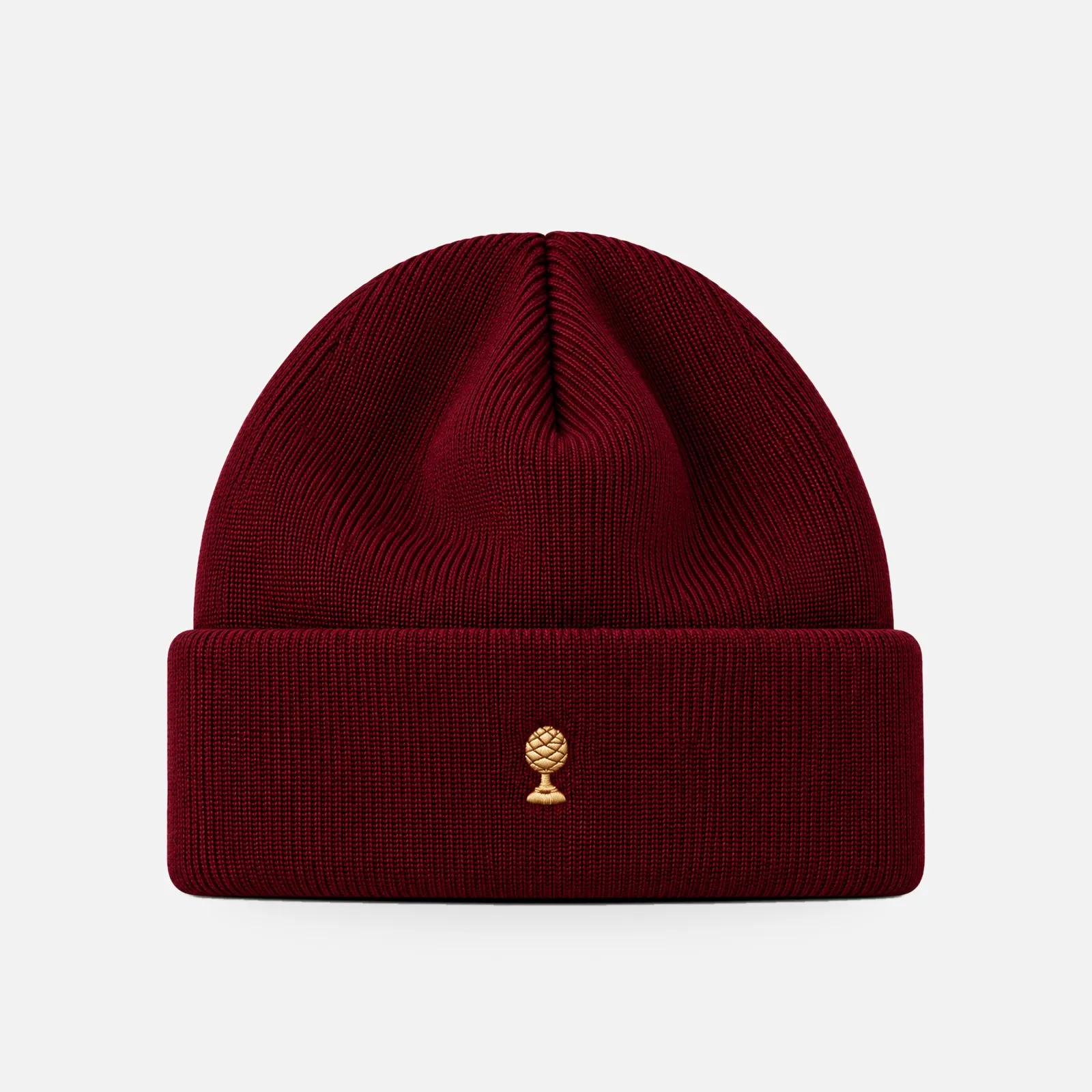 Merino-Beanie Gold Edition in bordeaux mit goldener Zirbelnuss