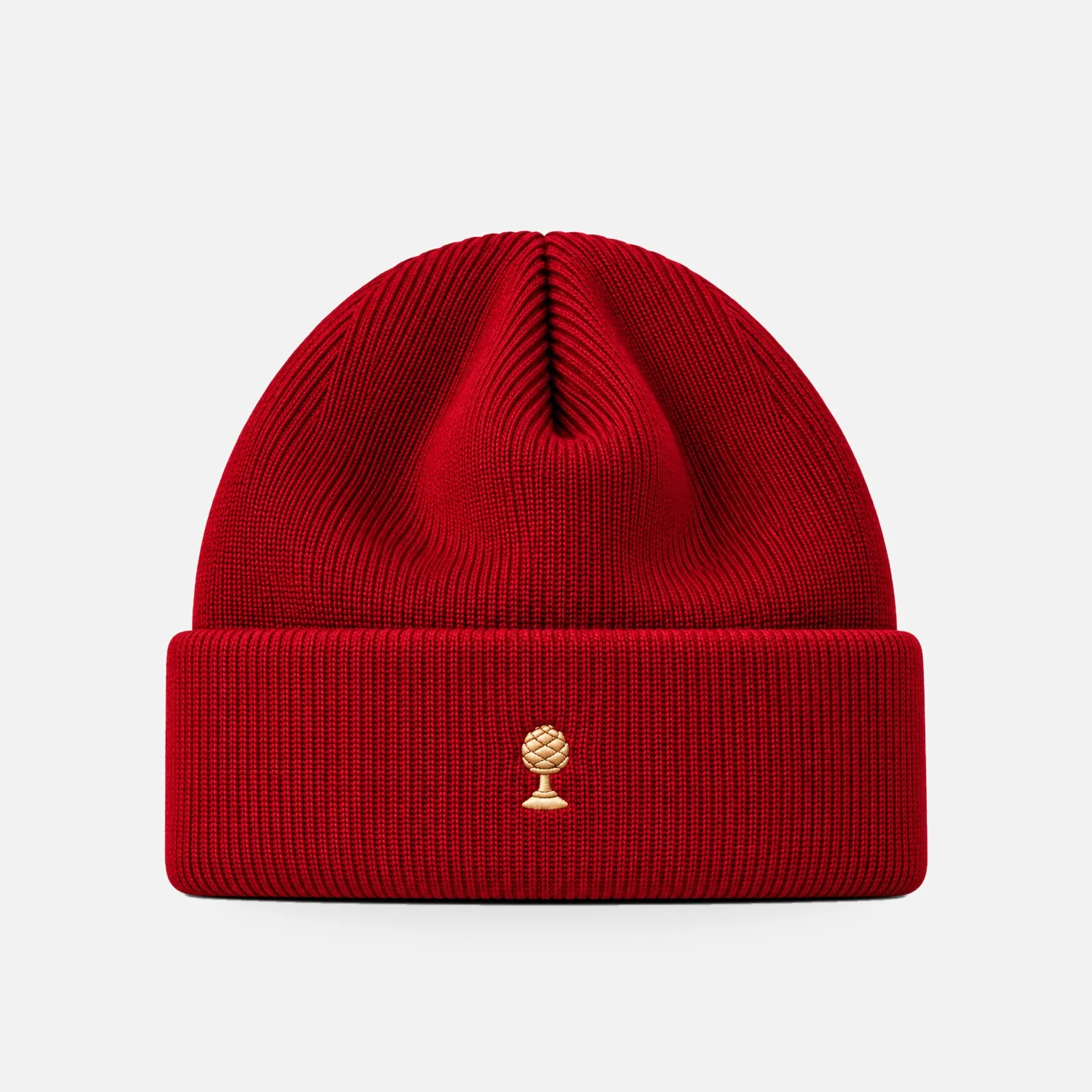 Merino-Beanie Gold Edition in rot mit goldener Zirbelnuss